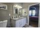 Bathroom featuring a double sink vanity and updated decor, with a doorway to the main bedroom at 116 Ridge Xing, Temple, GA 30179