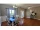 Elegant dining room with hardwood floors, chandelier, and natural light creating a warm ambiance at 116 Ridge Xing, Temple, GA 30179