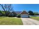 Well-maintained brick home featuring an attached garage, lush lawn, and mature landscaping at 116 Ridge Xing, Temple, GA 30179