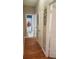 Hallway showcasing a hardwood floor with access to multiple rooms including a truck themed bathroom at 116 Ridge Xing, Temple, GA 30179