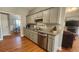 The kitchen features gray cabinets, granite countertops and stainless steel dishwasher at 116 Ridge Xing, Temple, GA 30179