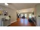 Living room with hardwood floors, a brick fireplace, and open access to other rooms at 116 Ridge Xing, Temple, GA 30179
