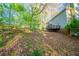 Backyard featuring mature trees, sloping landscape, and a wooden deck at 4510 Trumble Ter, Snellville, GA 30039