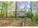 Backyard with mature trees, wooden deck, and view of the house at 4510 Trumble Ter, Snellville, GA 30039