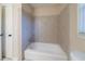 Bathroom featuring a tiled shower, bathtub, and neutral finishes at 4510 Trumble Ter, Snellville, GA 30039