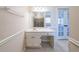Bathroom sink and vanity with a large mirror and view to the garden tub at 4510 Trumble Ter, Snellville, GA 30039