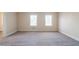 This bright bedroom features neutral walls, soft carpet, and two bright windows at 4510 Trumble Ter, Snellville, GA 30039