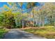 Charming two-story brick home with a long driveway surrounded by lush trees and greenery at 4510 Trumble Ter, Snellville, GA 30039