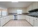 Bright kitchen featuring granite countertops, modern stainless steel appliances, and tile flooring at 4510 Trumble Ter, Snellville, GA 30039