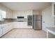 Bright kitchen featuring granite countertops, modern stainless steel appliances, and tile flooring at 4510 Trumble Ter, Snellville, GA 30039