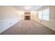 Spacious living room with a fireplace, built-in shelves, neutral paint, carpet and plenty of natural light at 4510 Trumble Ter, Snellville, GA 30039