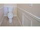 Toilet in a clean bathroom with molding and a small access panel at 4510 Trumble Ter, Snellville, GA 30039