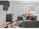 Bedroom area offering a comfortable couch, mini-fridge, and mounted TVs at 69 Country Place Ct, Alpharetta, GA 30005