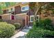Charming townhome featuring brick accents, well-maintained landscaping, and a vibrant red front door at 69 Country Place Ct, Alpharetta, GA 30005