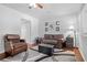 Inviting living room featuring hardwood floors, area rug, and neutral wall colors at 69 Country Place Ct, Alpharetta, GA 30005