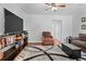 Living room with hardwood floors, a large area rug, and a television entertainment center at 69 Country Place Ct, Alpharetta, GA 30005
