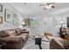 Comfortable living room features hardwood floors, area rug, and large picture window at 69 Country Place Ct, Alpharetta, GA 30005