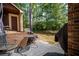 Cozy patio with outdoor seating, a grill, and a view of the wooded backyard at 69 Country Place Ct, Alpharetta, GA 30005