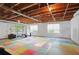 Spacious basement featuring a colorful floor, windows and exercise equipment at 7000 Hunters Knl, Atlanta, GA 30328