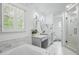 Bright bathroom with double vanity, soaking tub, and a glass-enclosed shower at 7000 Hunters Knl, Atlanta, GA 30328