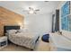 Bedroom featuring an accent wall, modern furniture, a ceiling fan and neutral carpet at 7000 Hunters Knl, Atlanta, GA 30328