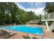 Large community pool with lounge chairs, a diving board, and lifeguard seating at 7000 Hunters Knl, Atlanta, GA 30328