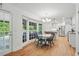 Sunlit dining area with a view to the outside, connecting indoor and outdoor spaces at 7000 Hunters Knl, Atlanta, GA 30328