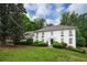 Charming two-story home with a manicured lawn, landscaping, and bright white exterior at 7000 Hunters Knl, Atlanta, GA 30328