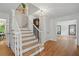 Inviting foyer with hardwood staircase and decorative lighting at 7000 Hunters Knl, Atlanta, GA 30328