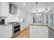 Modern kitchen with white cabinetry, stainless steel appliances, and ample counter space at 7000 Hunters Knl, Atlanta, GA 30328