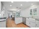 Bright kitchen features white cabinets, stainless steel appliances, and hardwood floors at 7000 Hunters Knl, Atlanta, GA 30328