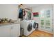 Functional laundry room with modern appliances and ample storage space at 7000 Hunters Knl, Atlanta, GA 30328
