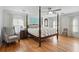 Serene bedroom features a four-poster bed and ample natural light at 7000 Hunters Knl, Atlanta, GA 30328