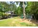 Community clubhouse, playground, and swing-set, surrounded by beautiful landscaping and greenery at 7000 Hunters Knl, Atlanta, GA 30328