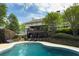 Beautiful backyard pool area with steps to a two story deck and a seating area at 7000 Hunters Knl, Atlanta, GA 30328