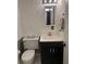 Powder room featuring a toilet, vanity and dark colored cabinet at 1181 Church St # D, Decatur, GA 30030