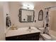 Bathroom with tub-shower combo, sleek vanity, decorative mirror and floral shower curtain at 1181 Church St # D, Decatur, GA 30030