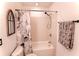 Bathroom with tub-shower, floral shower curtain and gray patterned hand towel at 1181 Church St # D, Decatur, GA 30030