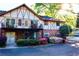 Charming townhome with brick facade, upstairs balconies, and colorful flowering bushes at 1181 Church St # D, Decatur, GA 30030