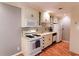 Clean kitchen featuring white cabinets, modern appliances, and wood-look flooring at 1181 Church St # D, Decatur, GA 30030