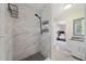 Modern bathroom with stylish marble tile, black shower fixtures, and a sleek vanity at 3200 Hampton Ridge Way, Snellville, GA 30078