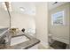 Bathroom featuring a white vanity, granite countertop, and a garden tub at 3200 Hampton Ridge Way, Snellville, GA 30078