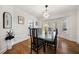 Dining room with glass table, modern chandelier, and wainscoting at 3200 Hampton Ridge Way, Snellville, GA 30078
