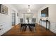 Formal dining room featuring a large glass table, modern chandelier, and wainscoting at 3200 Hampton Ridge Way, Snellville, GA 30078