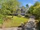 Inviting two-story home with a manicured lawn and a long driveway leading to the property at 3200 Hampton Ridge Way, Snellville, GA 30078