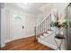 Foyer featuring hardwood floors, a staircase with decorative iron railing, and a front door with decorative glass at 3200 Hampton Ridge Way, Snellville, GA 30078