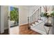 Bright foyer with hardwood floors, staircase with decorative iron railing, and view to the front yard at 3200 Hampton Ridge Way, Snellville, GA 30078