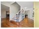 Open foyer boasts hardwood floors, staircase with decorative iron railing, and views into the living room and dining room at 3200 Hampton Ridge Way, Snellville, GA 30078