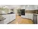 Bright kitchen with white cabinets, a gas cooktop island, and stainless steel appliances at 3200 Hampton Ridge Way, Snellville, GA 30078
