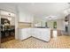 Open kitchen with white cabinets, a gas cooktop island, and an adjoining dining area at 3200 Hampton Ridge Way, Snellville, GA 30078